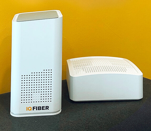 IQ Fiber equipment sitting on a table with a yellow background.