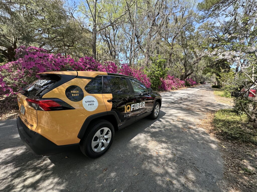 IQ Fiber vehicle parked among azaleas in Savannah