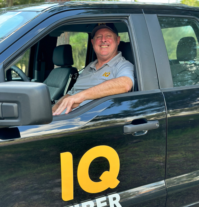 Construction coordinator sitting in an IQ Fiber vehicle.